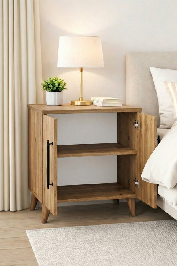 Lumen bedside table styled with a lamp and books on the open shelf