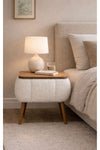 Angled view of the white Lina upholstered bedside table showing tapered legs - Sohowells