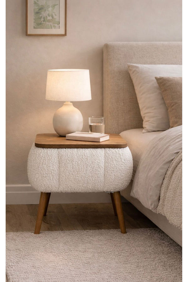 Angled view of the white Lina upholstered bedside table showing tapered legs - Sohowells