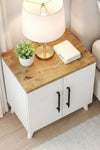 White and pine Lumen bedside table styled with a lamp and books