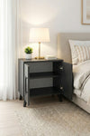 Anthracite Lumen bedside table with a lamp and books on the open shelf