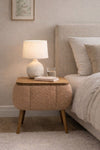 Angled view of the brown Lina upholstered bedside table showing tapered wooden legs - Sohowells
