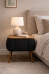 Angled view of the black Lina upholstered bedside table showing tapered legs - Sohowells
