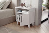 Angled view of Kommen white bedside cabinet showing raised legs - Sohowells