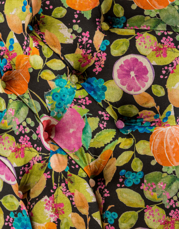 Side profile of citrus fruit patterned button back occasional chair