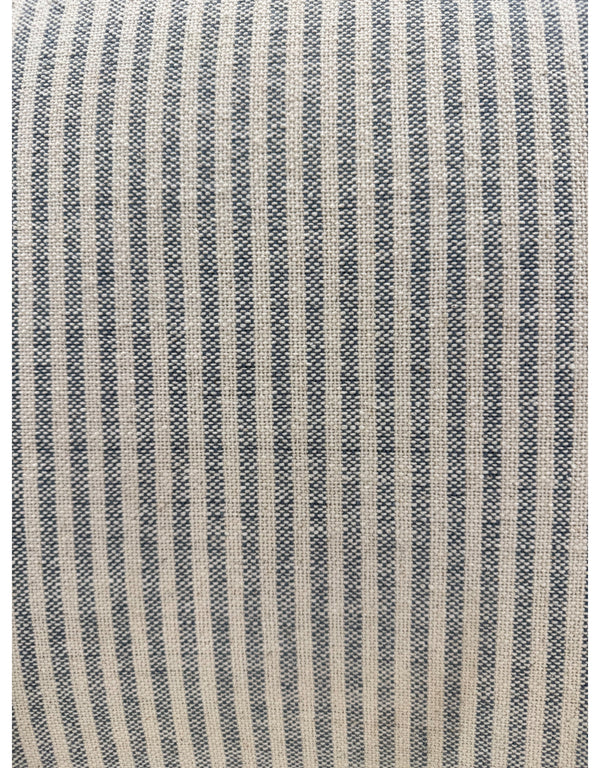 Close up of handloomed blue and white pinstripe cotton upholstery on accent armchair