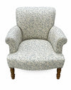 Side profile of blue Willow Boughs patterned armchair showing mango wood arms and upright back