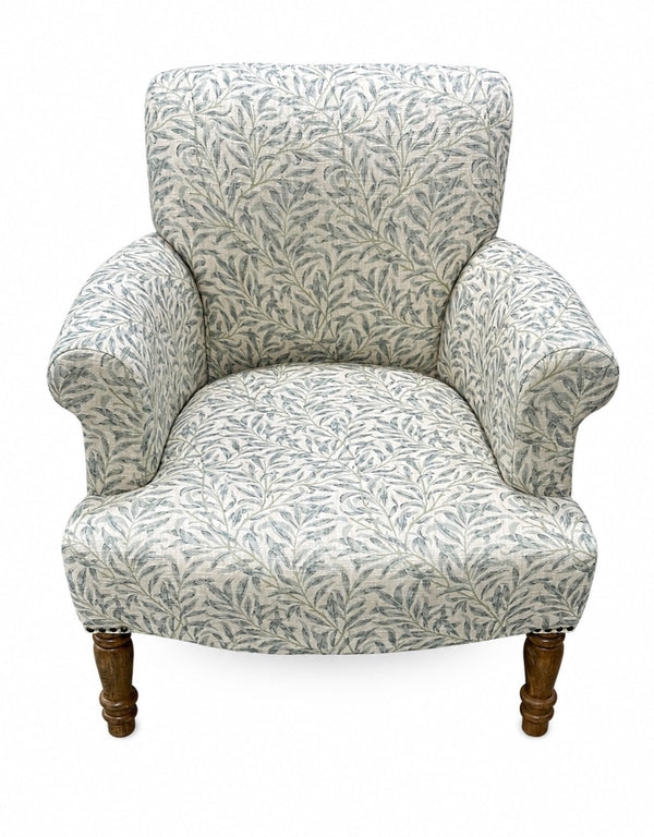 Side profile of blue Willow Boughs patterned armchair showing mango wood arms and upright back