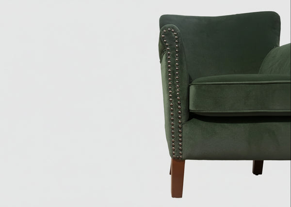 Green velvet armchair detail showing rolled arm and contrast studding - Sohowells