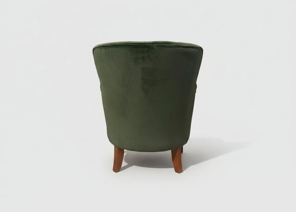 Forest green velvet studded armchair in a room setting - Sohowells