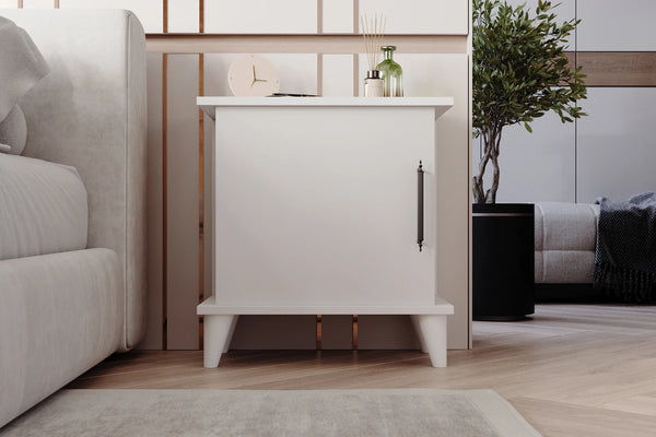Adela matt white bedside cabinet shown in a bedroom setting - Sohowells
