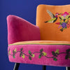 Close up of hand embroidered hummingbird detail on velvet armchair backrest - Sohowells