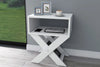 Matt white X-leg bedside table shown in a bedroom setting - Sohowells