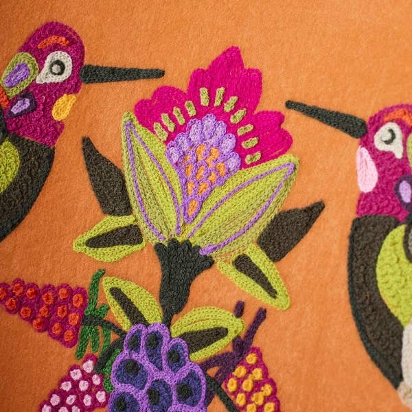 Embroidered orange velvet armchair showing floral detail along the base - Sohowells