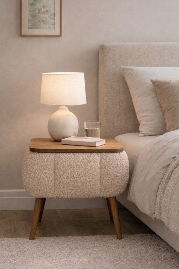 Angled view of the beige Lina upholstered bedside table showing tapered legs - Sohowells