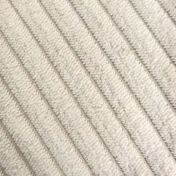 Detail of ribbed beige corduroy upholstery on swivel armchair - Sohowells