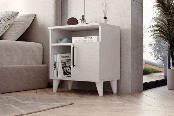 Kommen white bedside cabinet shown in a bedroom setting - Sohowells