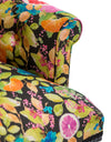 Close up of lemon and orange citrus print upholstery fabric on button back chair