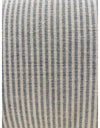 Close up of handloomed blue and white pinstripe cotton upholstery on accent armchair
