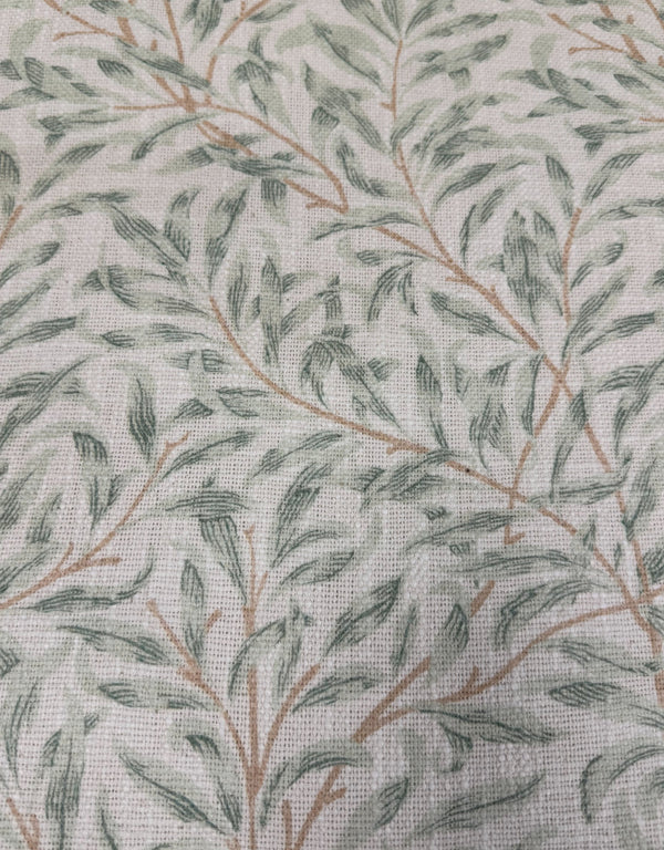 Close up of green William Morris willow leaf print cotton upholstery on occasional armchair
