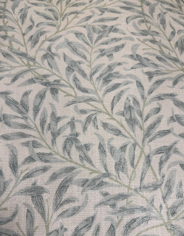 Close up of blue William Morris willow leaf print cotton upholstery on occasional armchair