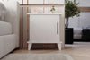 Adela matt white bedside cabinet shown in a bedroom setting - Sohowells