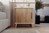 Adela light pine bedside cabinet shown in a bedroom setting - Sohowells