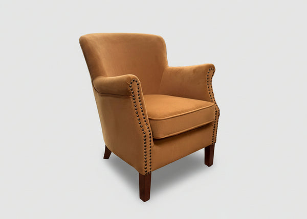 Gold velvet Cromarty armchair showing curved padded back and studded arms - Sohowells