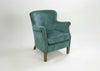 Teal velvet Cromarty armchair showing curved padded back - Sohowells